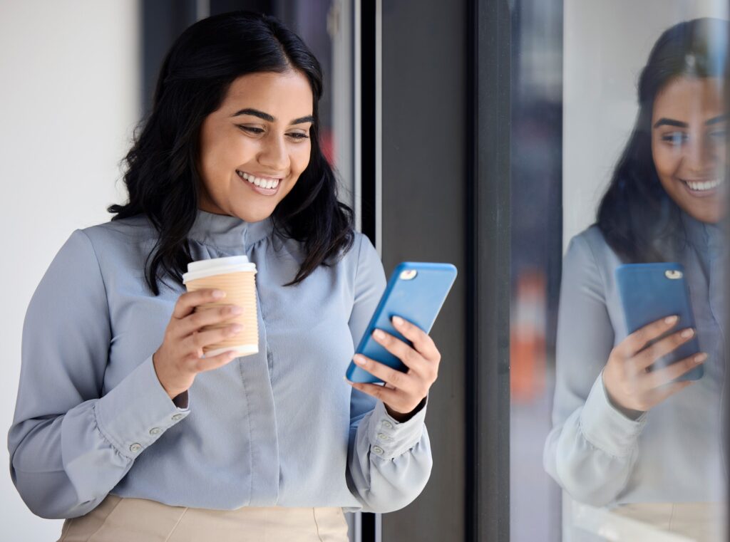 Smile, woman with phone in office on coffee break, browsing social media, surfing internet or typin