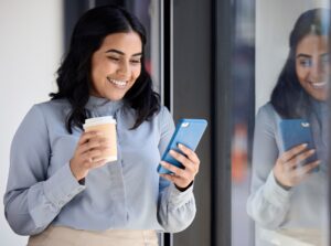Smile, woman with phone in office on coffee break, browsing social media, surfing internet or typin